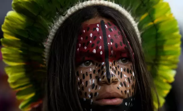 An Indigenous Pataxo youth takes part in the Free Earth camp, demanding the government pay more attention to Indigenous issues, in Brasilia, Brazil, Sunday, April 6, 2025. (AP Photo/Eraldo Peres)