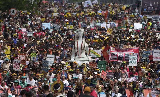Indigenous people march during the annual Free Earth camp, where Brazil's Indigenous communities discuss rights, territorial protection and their role in COP30, which will take place for the first time in the Amazon, in Brasilia, Brazil, Tuesday, April 8, 2025. (AP Photo/Eraldo Peres)