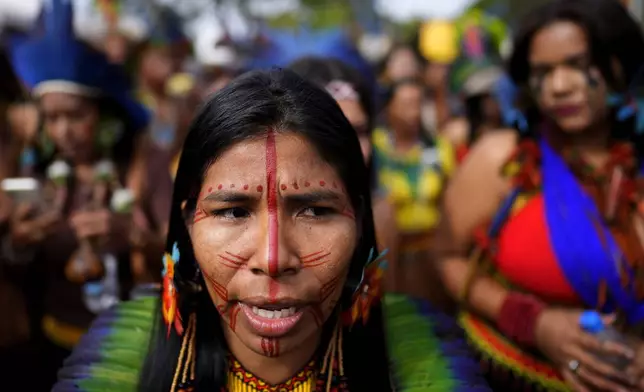 Indigenous people march during the annual Free Earth camp, where they discuss rights, territorial protection and their role in COP30 which will take place for the first time in the Amazon, in Brasilia, Brazil, Tuesday, April 8, 2025. (AP Photo/Eraldo Peres)