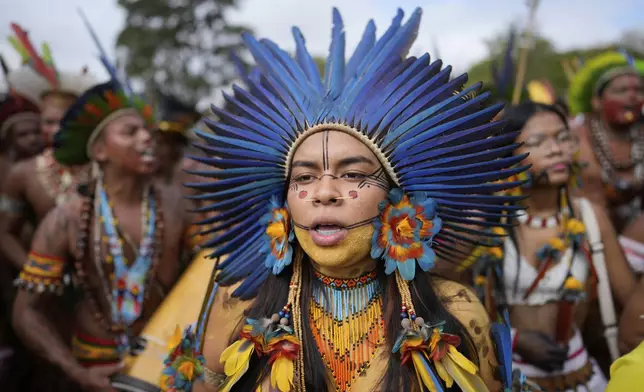 Indigenous people march during the annual Free Earth camp, where they discuss rights, territorial protection and their role in COP30, which will take place for the first time in the Amazon, in Brasilia, Brazil, Tuesday, April 8, 2025. (AP Photo/Eraldo Peres)
