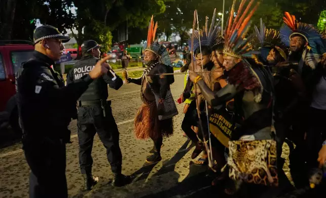 Indigenous people argue with police during the "We are the answer" march at the annual Free Earth camp, where they discuss rights, territorial protection and their role in COP30, which will take place in the Amazon, in Brasilia, Brazil, Thursday, April 10, 2025. (AP Photo/Eraldo Peres)