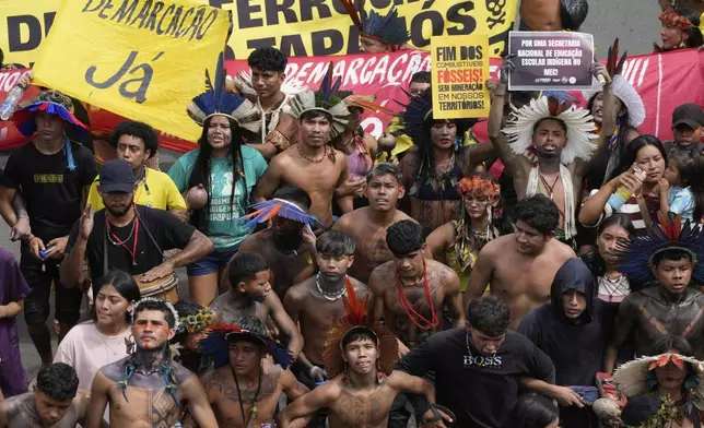 Indigenous people march during the annual Free Earth camp, where Brazil's Indigenous communities discuss rights, territorial protection and their role in COP30, which will take place for the first time in the Amazon, in Brasilia, Brazil, Tuesday, April 8, 2025. (AP Photo/Eraldo Peres)
