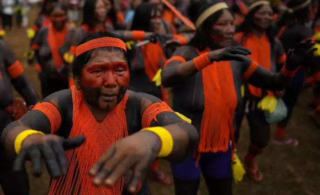 Kayapo Indigenous women dance during the Free Earth camp held annually to demand more government attention to Indigenous issues in Brasilia, Brazil, Monday, April 7, 2025. (AP Photo/Eraldo Peres)