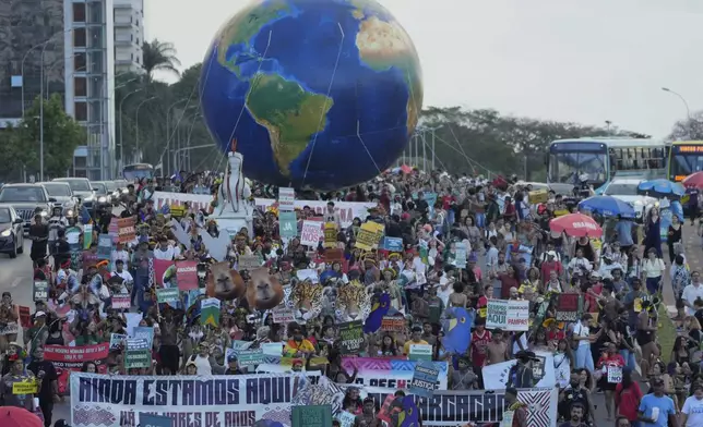 Indigenous people take part in the "We are the answer" march during the annual Free Earth camp, where they discuss rights, territorial protection and their role in COP30, which will take place for the first time in the Amazon, in Brasilia, Brazil, Thursday, April 10, 2025. (AP Photo/Eraldo Peres)