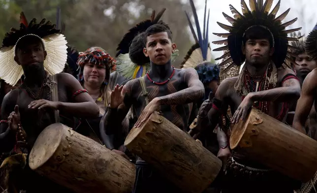 Tupiniquim Indigenous youths play drums during the Free Earth camp held annually to demand more government attention to Indigenous issues in Brasilia, Brazil, Monday, April 7, 2025. (AP Photo/Eraldo Peres)