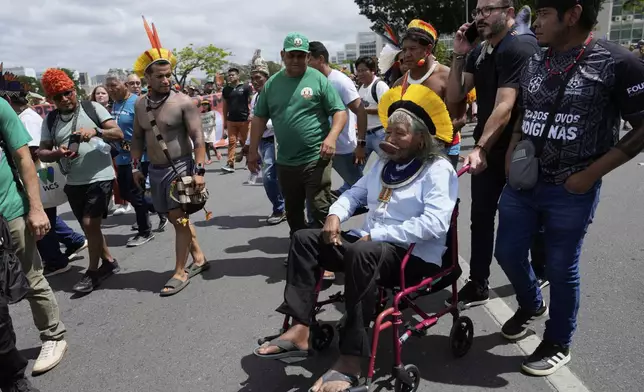 Indigenous Chief Raoni Metuktire sits in a wheelchair during the annual Free Earth camp, where Brazil's Indigenous communities discuss rights, territorial protection and their role in COP30, which will take place for the first time in the Amazon, in Brasilia, Brazil, Tuesday, April 8, 2025. (AP Photo/Eraldo Peres)