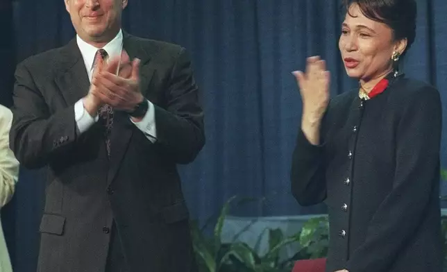 FILE - Vice President Gore applauds Alexis Herman while Herman blows a kiss to the audience after a reenactment of her swearing in as Secretary of Labor, May 9, 1997, in Washington. (AP Photo/Reggie Pearman, file)