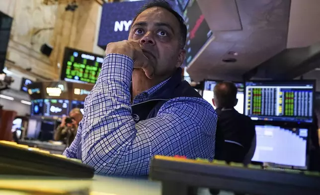 Specialist Dilip Patel works at his post on the floor of the New York Stock Exchange, Monday, April 28, 2025. (AP Photo/Richard Drew)