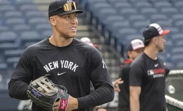 New York Yankees' Aaron Judge warms up before a baseball game against the Cleveland Guardians in Cleveland, Monday, April 21, 2025. (AP Photo/Phil Long)