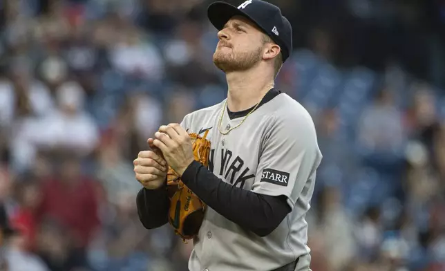 New York Yankees starting pitcher Clarke Schmidt pauses after giving up a solo home run to Cleveland Guardians' Kyle Manzardo during the third inning of a baseball game in Cleveland, Monday, April 21, 2025. (AP Photo/Phil Long)