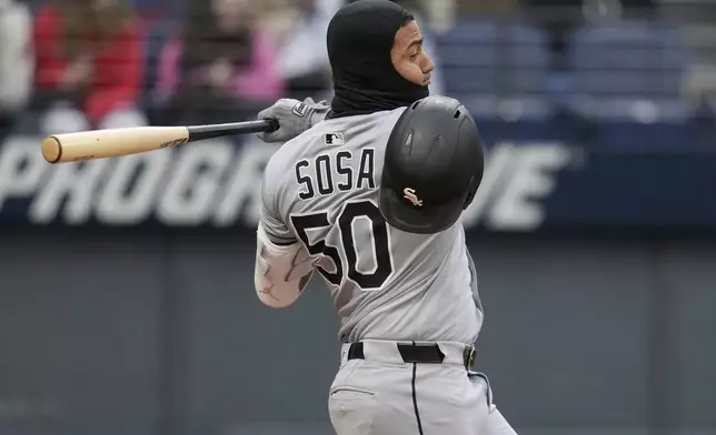Chicago White Sox's Lenyn Sosa (50) loses his batting helmet as he strikes out in the third inning of a baseball game against the Cleveland Guardians in Cleveland, Wednesday, April 9, 2025. (AP Photo/Sue Ogrocki)