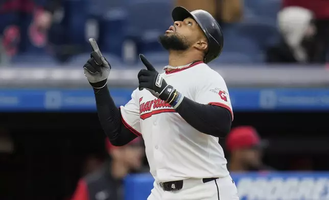 Cleveland Guardians' Carlos Santana gestures as he runs to home plate with a home run in the third inning of a baseball game against the Chicago White Sox in Cleveland, Wednesday, April 9, 2025. (AP Photo/Sue Ogrocki)