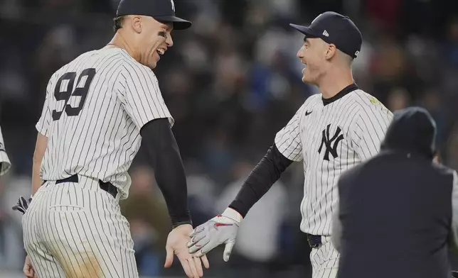 New York Yankees' Aaron Judge, left, celebrates with Cody Bellinger after a baseball game against the Kansas City Royals Wednesday, April 16, 2025, in New York. (AP Photo/Frank Franklin II)