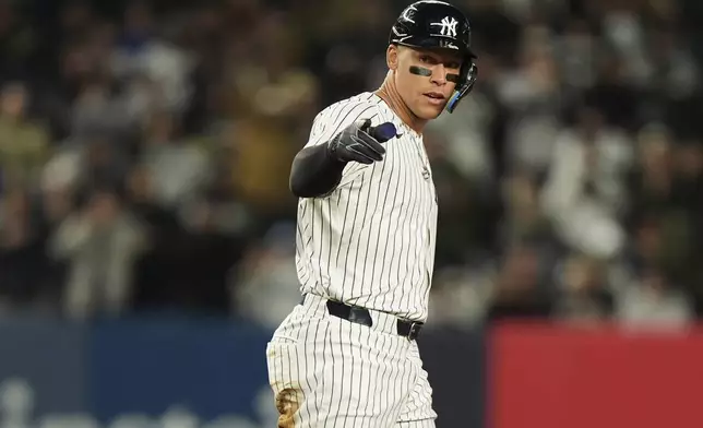 New York Yankees' Aaron Judge gestures to teammates after hitting a double during the third inning of a baseball game against the Kansas City Royals Wednesday, April 16, 2025, in New York. (AP Photo/Frank Franklin II)