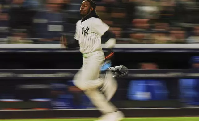 New York Yankees' Jazz Chisholm Jr. runs to home plate to score on a two-run double by Anthony Volpe during the third inning of a baseball game against the Kansas City Royals Wednesday, April 16, 2025, in New York. (AP Photo/Frank Franklin II)