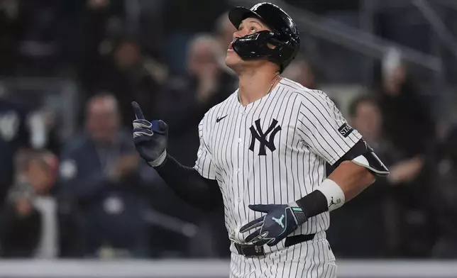 New York Yankees' Aaron Judge gestures as he runs the bases after hitting a home run during the seventh inning of a baseball game against the Kansas City Royals Wednesday, April 16, 2025, in New York. (AP Photo/Frank Franklin II)