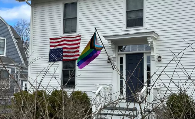 This house in Cumberland, Maine, shows a home with an LGBTQ pride flag and an upside down American flag, Wednesday, Aprill 16, 2025. (AP Photo/Patrick Whittle)
