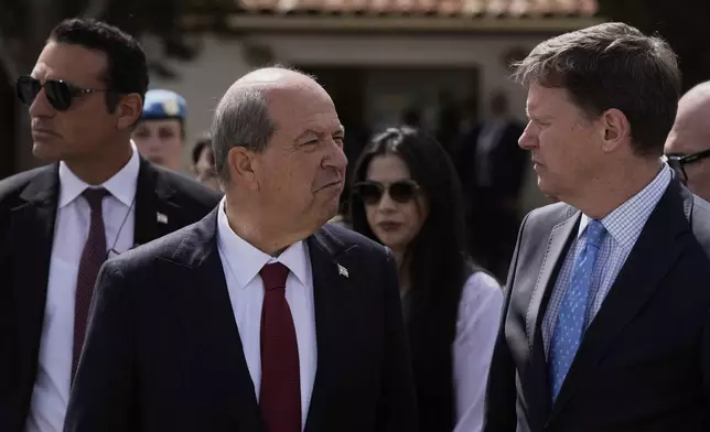 Turkish Cypriot leader Ersin Tatar, center, and U.N. Secretary General's Special Representative in Cyprus Colin Stewart, right, talk after a meeting with the Cyprus' President Nikos Christodoulides, at a U.N compound inside the U.N controlled buffer zone at abandoned Nicosia airport in divided capital Nicosia, Cyprus, Wednesday, April 2, 2025. (AP Photo/Petros Karadjias)