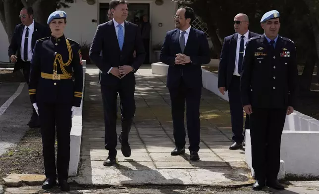 Cyprus' President Nikos Christodoulides, center right, and the U.N. Secretary General's Special Representative in Cyprus Colin Stewart, center left, talk after a meeting with the Turkish Cypriot leader Ersin Tatar, at a U.N compound inside the U.N controlled buffer zone at abandoned Nicosia airport in divided capital Nicosia, Cyprus, Wednesday, April 2, 2025. (AP Photo/Petros Karadjias)