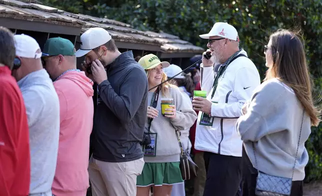 Patrons line up to use courtesy phones during a practice around at the Masters golf tournament, Wednesday, April 9, 2025, in Augusta, Ga. (AP Photo/Ashley Landis)