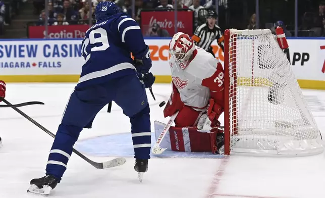 Detroit Red Wings goalie Cam Talbot (39) makes a stop on a shot by Toronto Maple Leafs' Pontus Holmberg (29) during the second period of an NHL hockey game Thursday, April 17, 2025, in Toronto. (Jon Blacker/The Canadian Press via AP)