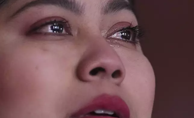 With her eyes filled with tears, Marilu Domingo Ortiz, whose husband was taken into custody by ICE agents after they smashed a window of their family car, describes the arrest during an interview at their home, Wednesday, April 16, 2025, in New Bedford, Mass. (AP Photo/Charles Krupa)