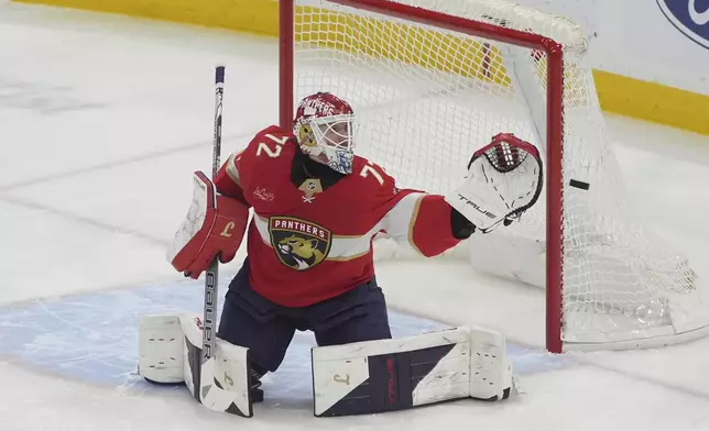 Florida Panthers goaltender Sergei Bobrovsky (72) deflects a shot on goal during the first period of an NHL hockey game against the Detroit Red Wings, Thursday, April 10, 2025, in Sunrise, Fla. (AP Photo/Marta Lavandier)