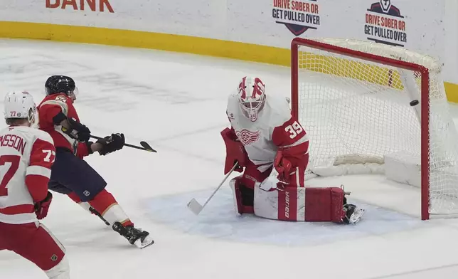 Florida Panthers center Brad Marchand (63) scores a goal against Detroit Red Wings goaltender Cam Talbot (39) during the second period of an NHL hockey game, Thursday, April 10, 2025, in Sunrise, Fla. (AP Photo/Marta Lavandier)