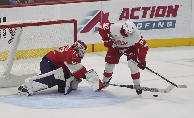 Florida Panthers goaltender Sergei Bobrovsky (72) defends against a shot by Detroit Red Wings center Marco Kasper (92) during the second period of an NHL hockey game, Thursday, April 10, 2025, in Sunrise, Fla. (AP Photo/Marta Lavandier)