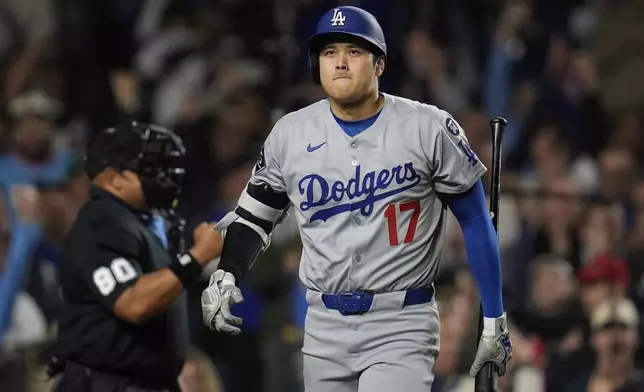 Los Angeles Dodgers designated hitter Shohei Ohtani (17) returns to the dugout after striking out during the ninth inning of a baseball game against the Chicago Cubs, Wednesday, April 23, 2025, in Chicago. (AP Photo/Erin Hooley)