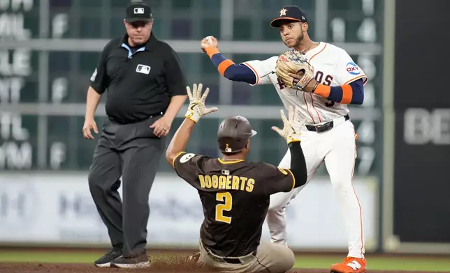Houston Astros shortstop Jeremy Peña (3) tags San Diego Padres' Xander Bogaerts (2) out at second base as Oscar Gonzales ground into a force out during the sixth inning of a baseball game Sunday, April 20, 2025, in Houston. (AP Photo/Karen Warren)