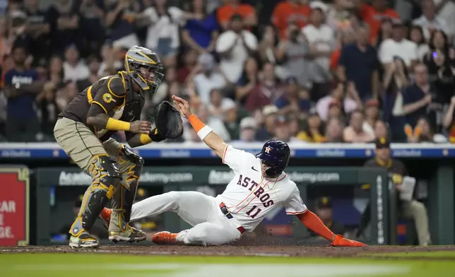 Houston Astros' Cam Smith (11) scores a run on Yordan Alvarez's sacrifice fly against the San Diego Padres during the fifth inning of a baseball game Sunday, April 20, 2025, in Houston. (AP Photo/Karen Warren)