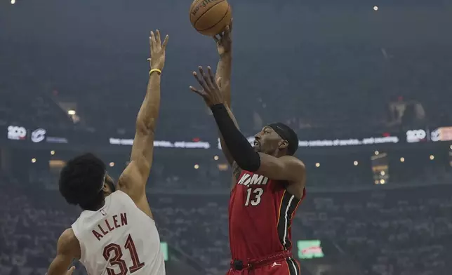 Miami Heat center Bam Adebayo (13) shoots over Cleveland Cavaliers center Jarrett Allen (31) in the first half in Game 1 of an NBA first-round playoff series, Sunday, April 20, 2025, in Cleveland. (AP Photo/Sue Ogrocki)