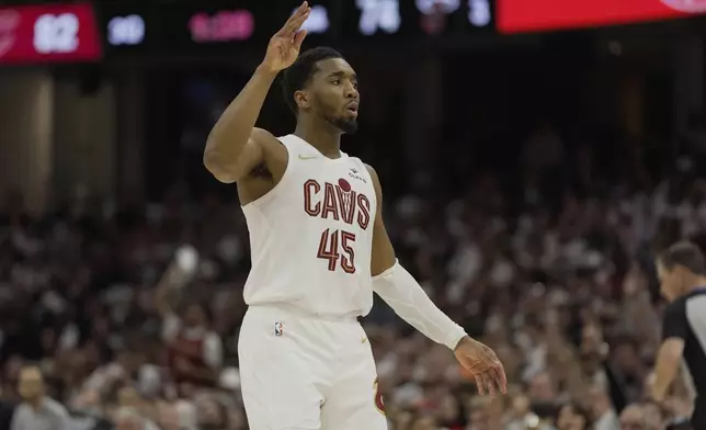 Cleveland Cavaliers guard Donovan Mitchell (45) gestures after hitting a three-point basket in the second half in Game 1 of an NBA first-round playoff series against the Miami Heat, Sunday, April 20, 2025, in Cleveland. (AP Photo/Sue Ogrocki)