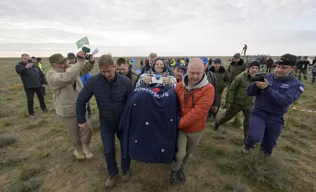 Roscosmos cosmonaut Ivan Vagner gestures as he is carried to a medical tent shortly after landing in a Soyuz MS-26 spacecraft with fellow cosmonaut Alexey Ovchinin and NASA astronaut Don Pettit near the town of Zhezkazgan, Kazakhstan, Sunday, April 20, 2025. (Bill Ingalls/NASA via AP)
