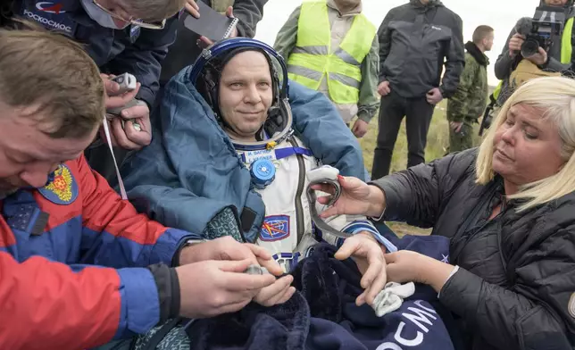 Roscosmos cosmonaut Ivan Vagner sits outside the Soyuz MS-26 spacecraft after landing with NASA astronaut Don Pettit and fellow cosmonaut Alexey Ovchinin in a remote area near the town of Zhezkazgan, Kazakhstan on Sunday, April 20, 2025. (Bill Ingalls/NASA via AP)