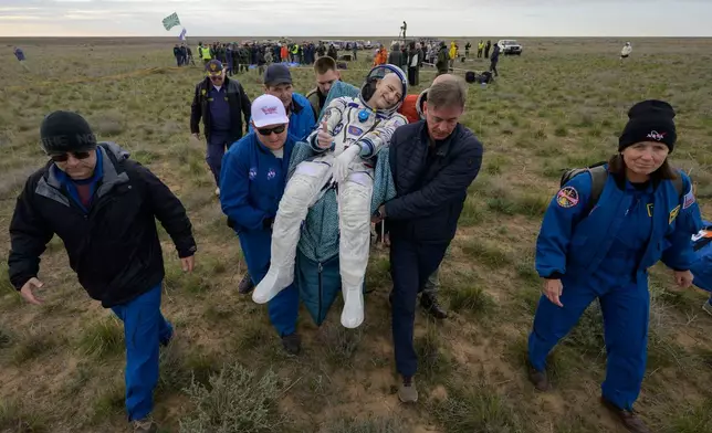 NASA astronaut Don Pettit gestures as he is carried to a medical tent shortly after landing in a Soyuz MS-26 spacecraft with Roscosmos cosmonauts Alexey Ovchinin and Ivan Vagner near the town of Zhezkazgan, Kazakhstan, Sunday, April 20, 2025. (Bill Ingalls/NASA via AP)