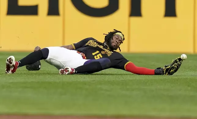 Pittsburgh Pirates center fielder Oneil Cruz reaches but cannot catch a ball hit by Washington Nationals' Paul DeJong during the second inning of a baseball game Monday, April 14, 2025, in Pittsburgh. (AP Photo/Matt Freed)