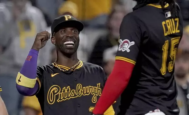 Pittsburgh Pirates' Andrew McCutchen, left, celebrates with Oneil Cruz, right, after defeating the Washington Nationals in a baseball game Monday, April 14, 2025, in Pittsburgh. (AP Photo/Matt Freed)