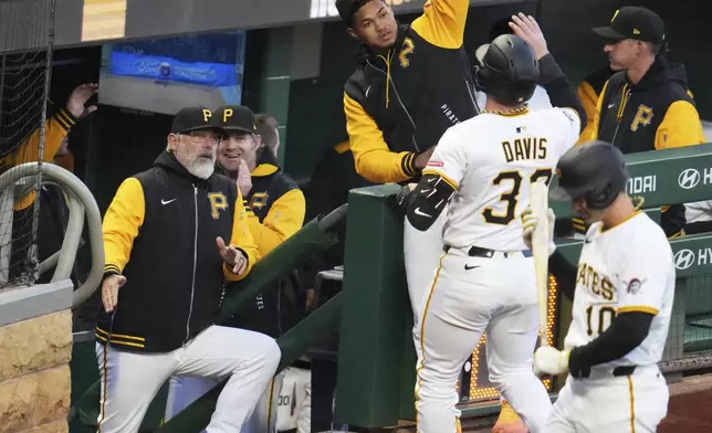Pittsburgh Pirates' Henry Davis, second from right, celebrates as he returns to the dugout after hitting a solo home run off Washington Nationals pitcher Mitchell Parker during the fifth inning of a baseball game in Pittsburgh, Wednesday, April 16, 2025. (AP Photo/Gene J. Puskar)