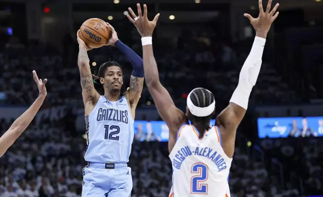 Memphis Grizzlies guard Ja Morant (12) looks to pass the ball away from Oklahoma City Thunder guard Shai Gilgeous-Alexander (2) during the second half in Game 1 of an NBA first-round playoff series, Sunday, April 20, 2025, in Oklahoma City. (AP Photo/Nate Billings)