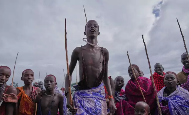 Children of the Maasai tribe perform a traditional jumping dance, during the Enkipaata ceremony, a Maasai male rite of passage, specifically the initiation of boys, marking the transition from childhood to becoming a moran (warrior) in Olaimutiai, Narok County, Kenya Thursday, April 24, 2024. (AP Photo/Brian Inganga)