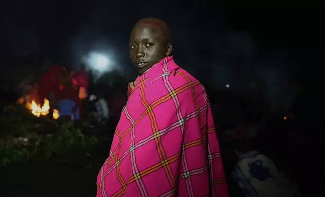 Samuel Noorkairish, 15 years old, of the Maasai tribe poses for a photo, during the Enkipaata ceremony, a Maasai male rite of passage, specifically the initiation of boys, marking the transition from childhood to becoming a moran (warrior) in Olaimutiai, Narok County, Kenya Wednesday, April 23, 2024. (AP Photo/Brian Inganga)