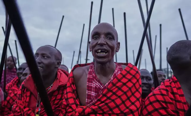 Men of the Maasai tribe perform a traditional dance, during a Maasai male rite of passage, specifically the initiation of boys, marking the transition from childhood to becoming a moran (warrior) in Olaimutiai, Narok County, Kenya Wednesday, April 23, 2024. (AP Photo/Brian Inganga)
