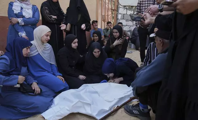 Palestinians mourn over the body of Kinan Edwan, 2 years old, killed in an Israeli army airstrike, during his funeral in Khan Younis, southern Gaza Strip, Saturday, April 19, 2025. (AP Photo/Abdel Kareem Hana)