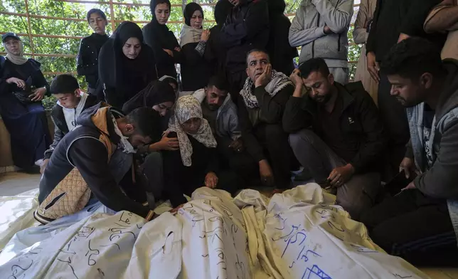 Palestinians mourn over the bodies of their relatives killed in an Israeli army airstrike, during their funeral in Khan Younis, southern Gaza Strip, Saturday, April 19, 2025. (AP Photo/Abdel Kareem Hana)