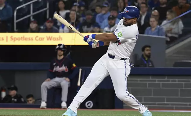 Toronto Blue Jays' Anthony Santander hits a double against the Atlanta Braves in first inning baseball action in Toronto on Wednesday, April 16, 2025. (Jon Blacker/The Canadian Press via AP)