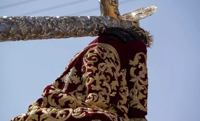 A statue of Jesus of Nazareth wears a tunic created by weavers at the Maria Auxiliadora embroidery workshop, during a Lenten season procession in Antigua, Guatemala, Sunday, April 6, 2025. (AP Photo/Santiago Billy)