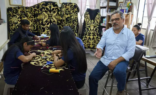 Guatemalan artist Alejandro Juarez gives an interview at the Maria Auxiliadora embroidery workshop in San Miguel Escobar, Guatemala, Wednesday, April 2, 2025. (AP Photo/Moises Castillo)