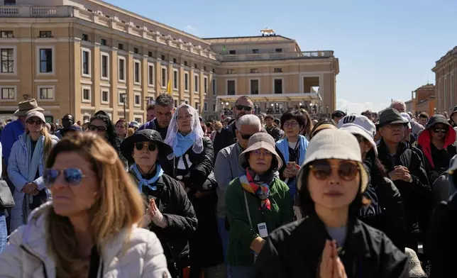 People attend the funeral of Pope Francis in St. Peter's Square at the Vatican, Saturday, April 26, 2025. (AP Photo/Andreea Alexandru)